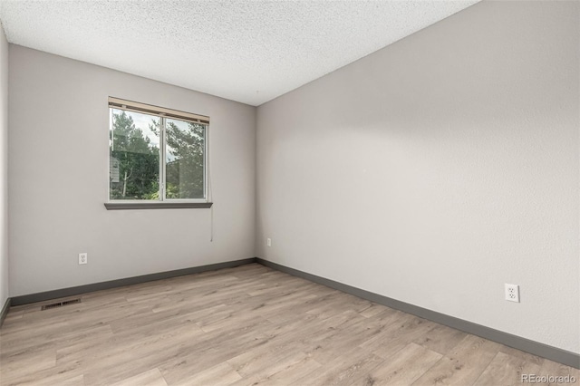 10172 Woodrose Ln, Highlands Ranch, CO 80129 - unfurnished room featuring light wood-style floors and a textured ceiling