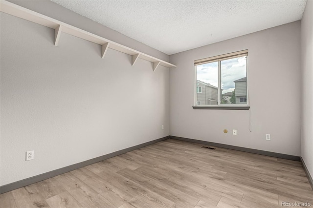 10172 Woodrose Ln, Highlands Ranch, CO 80129 - empty room featuring a textured ceiling and light wood-style floors