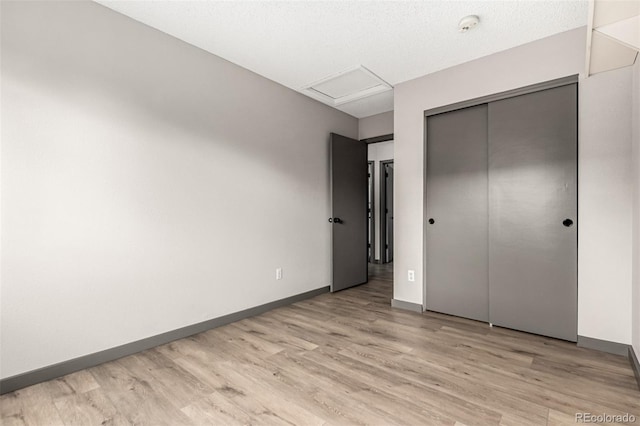 10172 Woodrose Ln, Highlands Ranch, CO 80129 - unfurnished bedroom with attic access, light wood-style floors, and a closet
