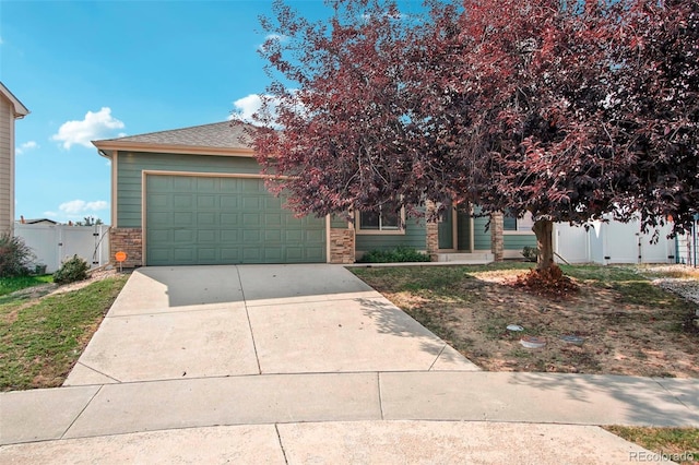 view of property hidden behind natural elements featuring a garage