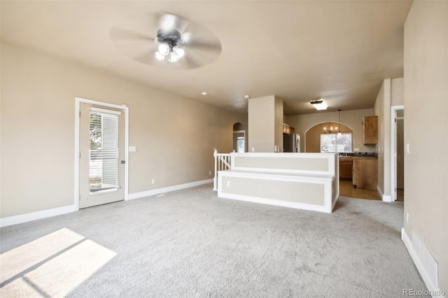 unfurnished living room with light carpet and ceiling fan