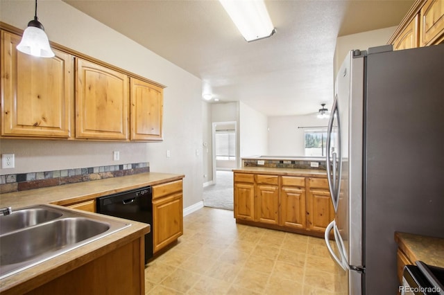 kitchen featuring ceiling fan, stainless steel fridge, sink, decorative light fixtures, and black dishwasher