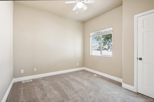 spare room featuring ceiling fan and carpet flooring