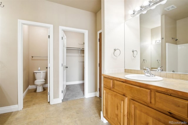 bathroom with tile patterned flooring, vanity, and toilet