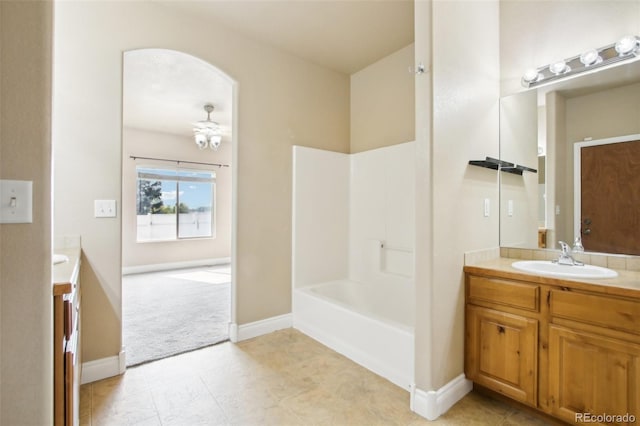 bathroom with bathing tub / shower combination, vanity, and ceiling fan