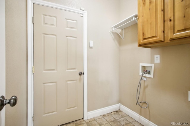 clothes washing area with washer hookup and cabinets