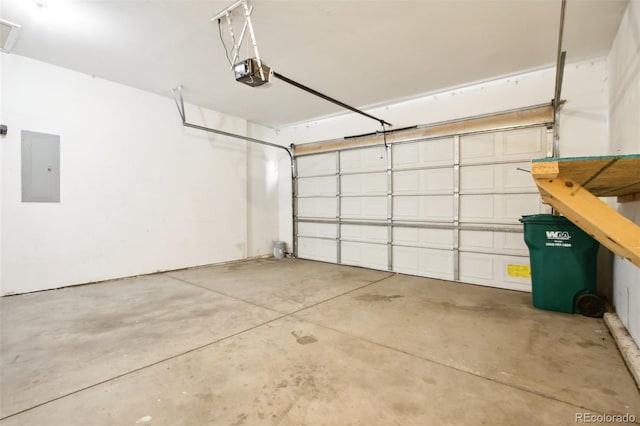 garage with a garage door opener and electric panel