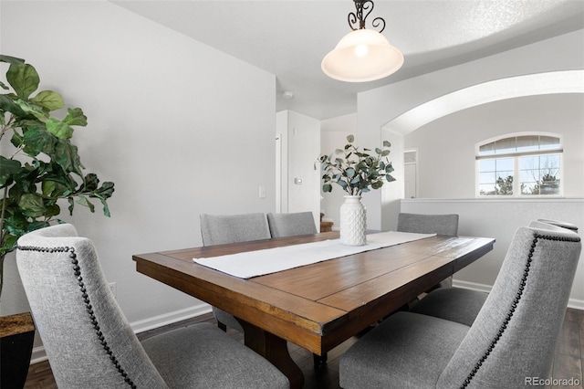 dining space with dark hardwood / wood-style floors