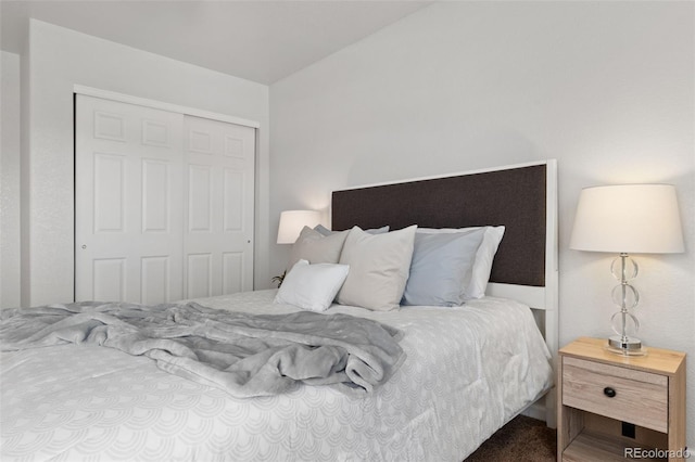 bedroom with carpet and a closet