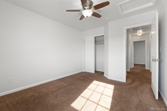 unfurnished bedroom featuring dark colored carpet, ceiling fan, and a closet