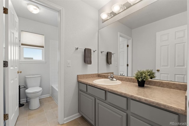 full bathroom with vanity, bathtub / shower combination, tile patterned floors, and toilet