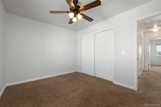 unfurnished bedroom with carpet flooring, ceiling fan, and a closet