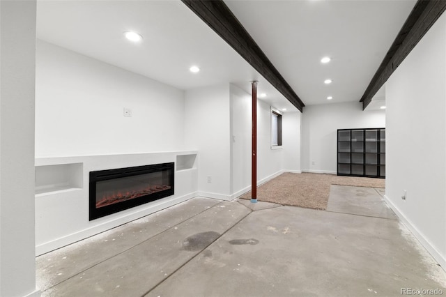 unfurnished living room featuring beam ceiling