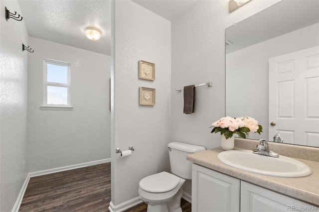 bathroom featuring vanity, hardwood / wood-style flooring, and toilet