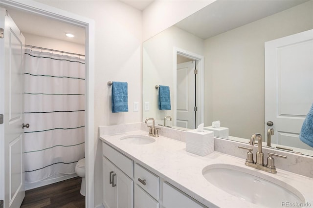 5805 Red Barn Ave, Longmont, CO 80504 - full bathroom with double vanity, toilet, wood finished floors, a shower with curtain, and recessed lighting