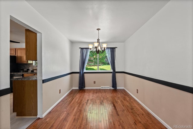4627 S Norfolk Way, Aurora, CO 80015 - unfurnished dining area featuring a chandelier and light wood finished floors