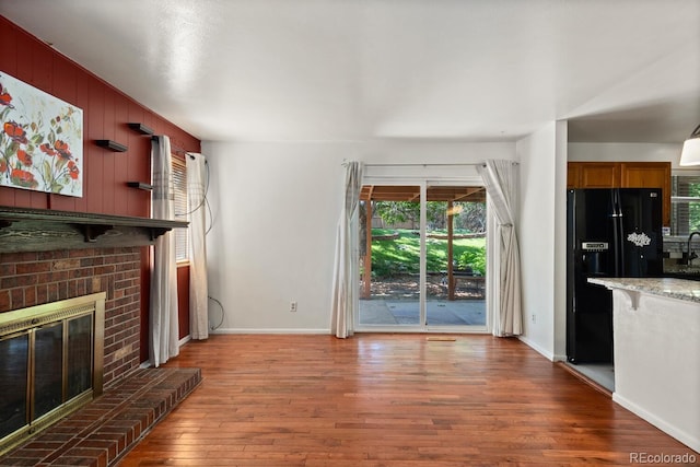 4627 S Norfolk Way, Aurora, CO 80015 - unfurnished living room featuring a fireplace and wood finished floors