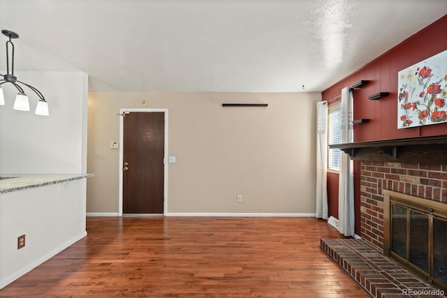 4627 S Norfolk Way, Aurora, CO 80015 - unfurnished living room with wood finished floors and a fireplace