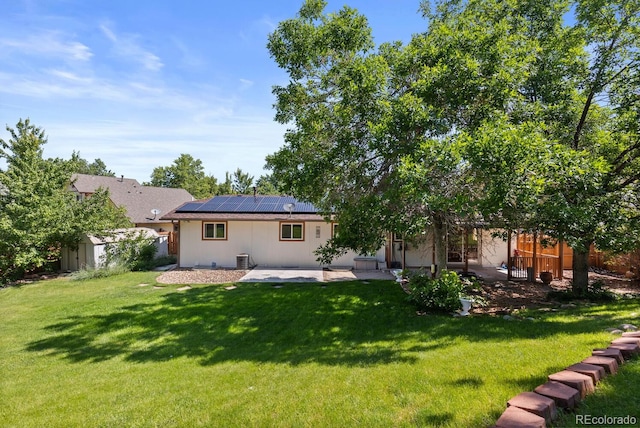 4627 S Norfolk Way, Aurora, CO 80015 - rear view of property with a patio area, solar panels, a lawn, and a shed