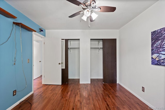 4627 S Norfolk Way, Aurora, CO 80015 - unfurnished bedroom with multiple closets, wood finished floors, and ceiling fan