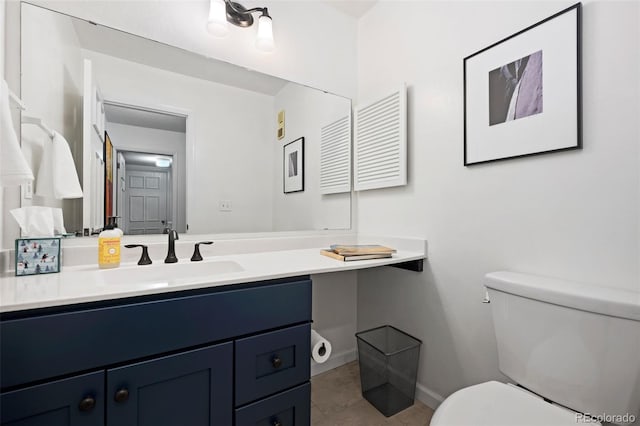 bathroom with toilet, baseboards, tile patterned floors, and vanity