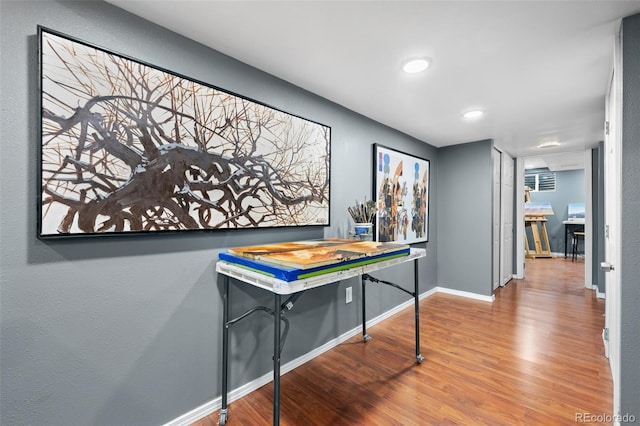 recreation room featuring recessed lighting, baseboards, and wood finished floors