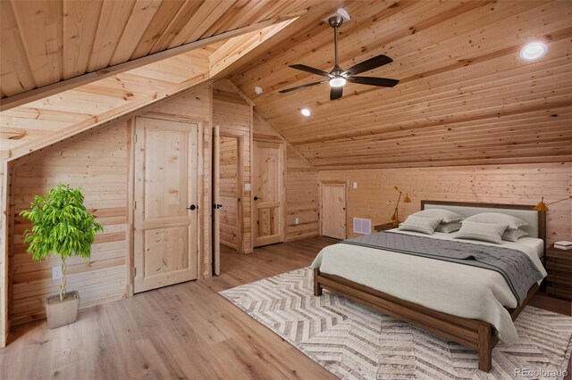 bedroom with vaulted ceiling, wood walls, wood ceiling, and wood finished floors