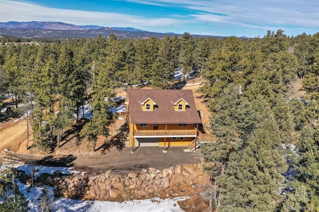 bird's eye view featuring a mountain view and a view of trees