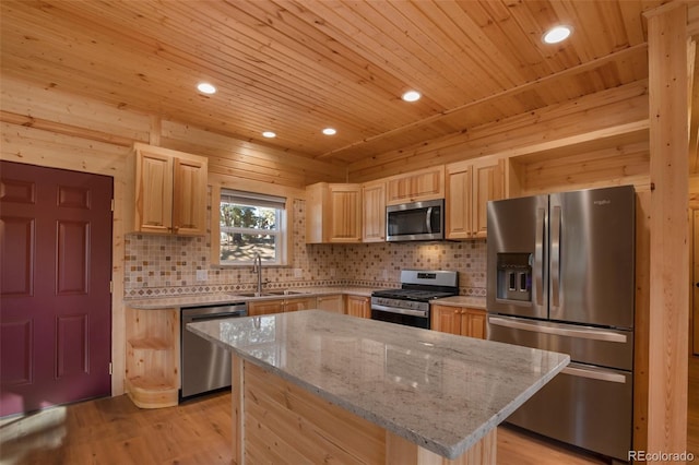 kitchen featuring a sink, light stone countertops, appliances with stainless steel finishes, and light brown cabinetry