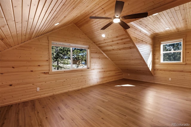 additional living space featuring wood walls, wood ceiling, lofted ceiling, and wood finished floors