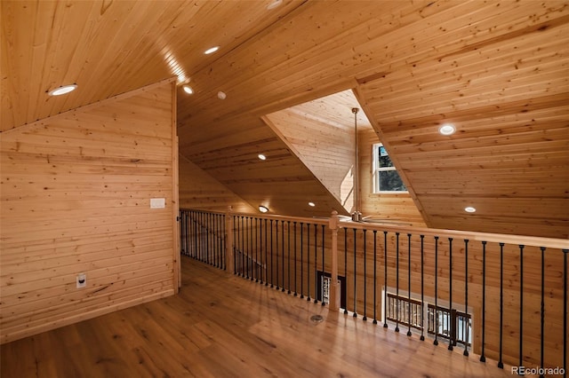 bonus room with wood finished floors, wood ceiling, wooden walls, and vaulted ceiling