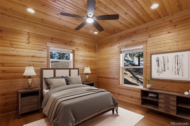 bedroom with wooden ceiling, recessed lighting, wood finished floors, and wood walls