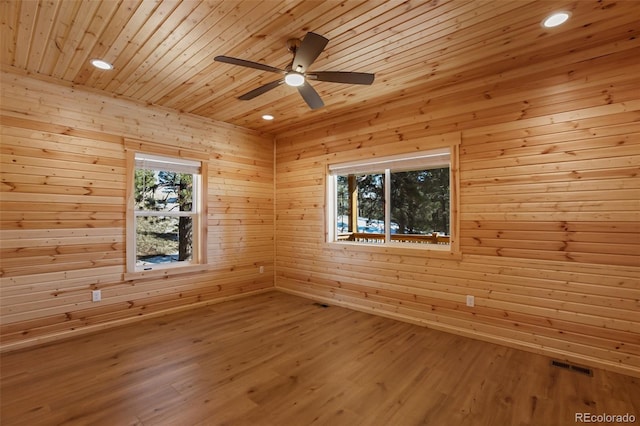 spare room with a sauna, visible vents, wood ceiling, and wood finished floors