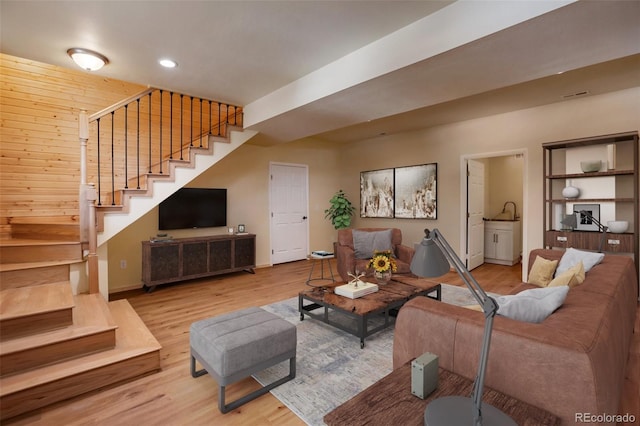 living area featuring recessed lighting, baseboards, wood finished floors, and stairs