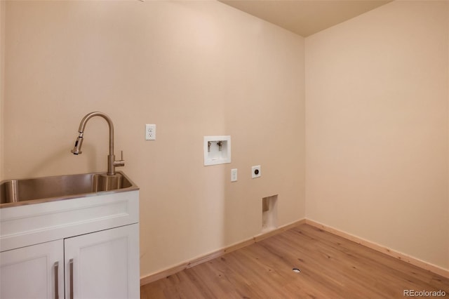 laundry area featuring hookup for a washing machine, hookup for an electric dryer, cabinet space, a sink, and light wood-type flooring