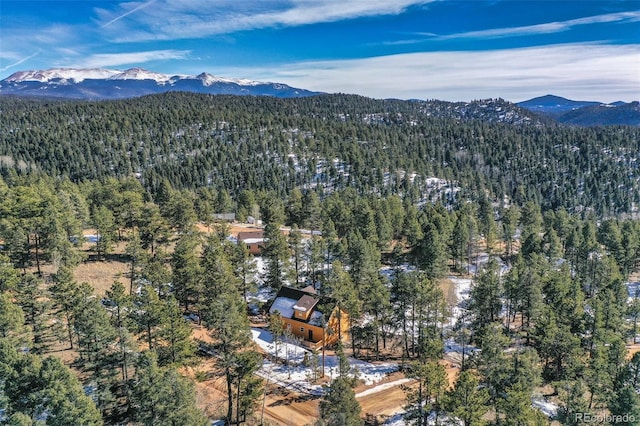 drone / aerial view with a mountain view and a forest view