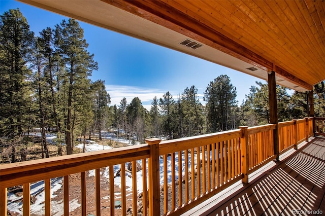 wooden deck featuring visible vents