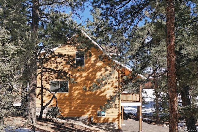 view of side of home featuring a wooden deck