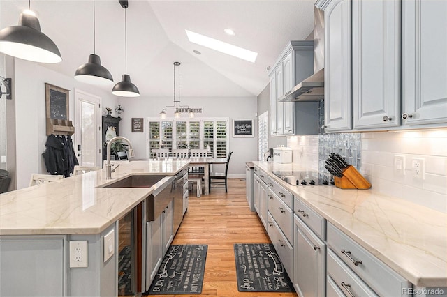 6940 Saddleback Ave, Firestone, CO 80504 - kitchen with a skylight, black electric cooktop, vaulted ceiling, backsplash, and a sink