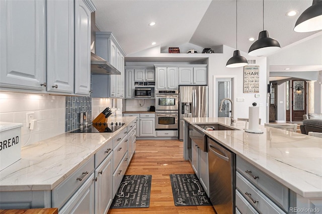 6940 Saddleback Ave, Firestone, CO 80504 - kitchen with appliances with stainless steel finishes, gray cabinets, vaulted ceiling, light wood-type flooring, and a sink