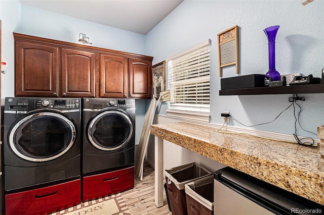 6940 Saddleback Ave, Firestone, CO 80504 - washroom with washer and dryer, cabinet space, and light wood-style flooring