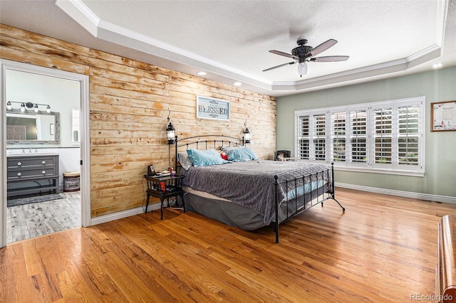 6940 Saddleback Ave, Firestone, CO 80504 - bedroom with a raised ceiling, a textured ceiling, wood finished floors, baseboards, and ornamental molding