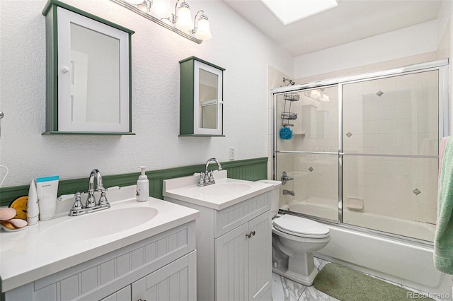 6940 Saddleback Ave, Firestone, CO 80504 - bathroom featuring combined bath / shower with glass door, toilet, and two vanities