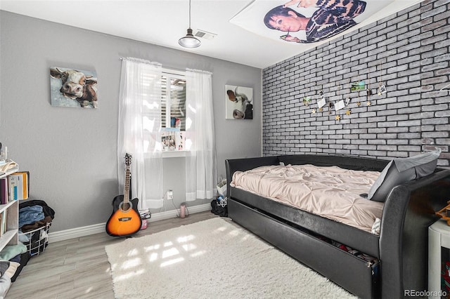 6940 Saddleback Ave, Firestone, CO 80504 - bedroom featuring wood finished floors, baseboards, and an accent wall