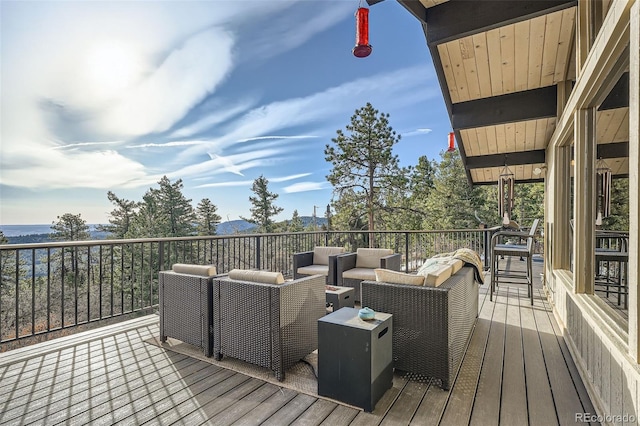 deck featuring a mountain view and outdoor lounge area