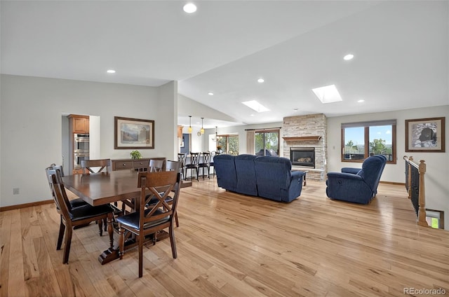 723 Orion Dr, Colorado Springs, CO 80906 - dining area with a skylight, vaulted ceiling, healthy amount of natural light, light wood-type flooring, and baseboards