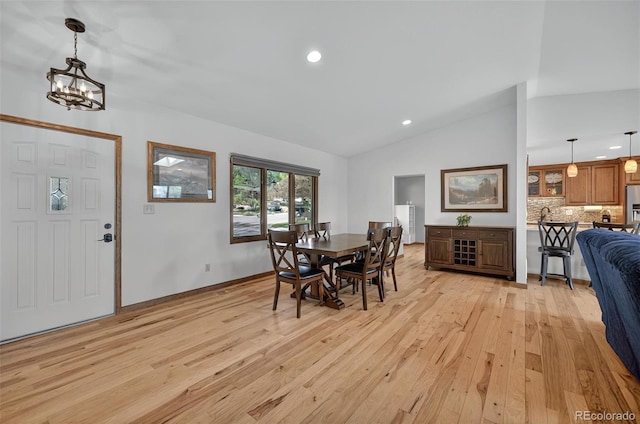723 Orion Dr, Colorado Springs, CO 80906 - dining space with light wood-style flooring, vaulted ceiling, recessed lighting, and a chandelier