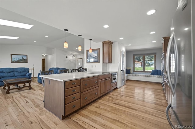 723 Orion Dr, Colorado Springs, CO 80906 - kitchen with stainless steel appliances, light wood-style floors, open floor plan, light countertops, and recessed lighting