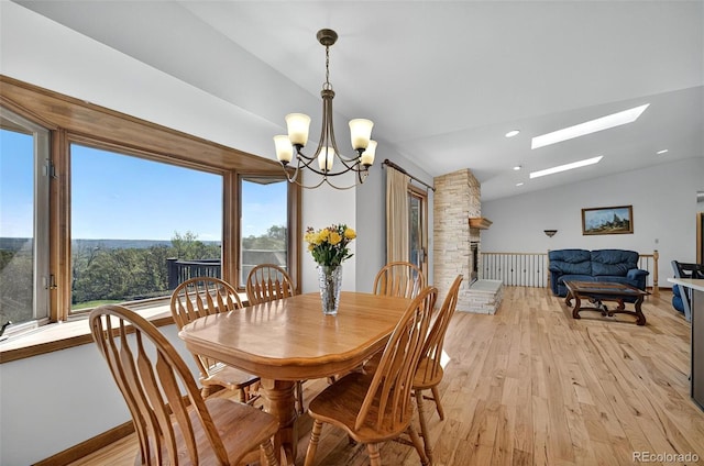 723 Orion Dr, Colorado Springs, CO 80906 - dining room featuring a chandelier, light wood-style flooring, a skylight, lofted ceiling, and recessed lighting