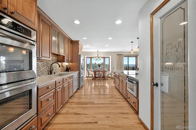 723 Orion Dr, Colorado Springs, CO 80906 - kitchen with a sink, brown cabinets, stainless steel appliances, and recessed lighting